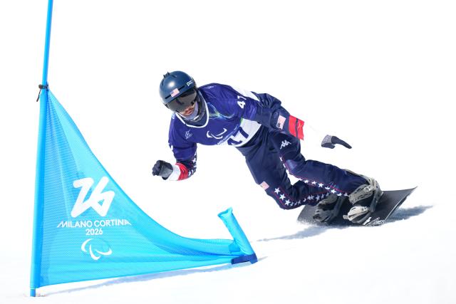 (260313) -- CORTINA D'AMPEZZO, March 13, 2026 (Xinhua) -- Zach Miller of the United States competes during the Para Snowboard Men's Banked Slalom SB-LL2 event at the Milan-Cortina 2026 Paralympic Winter Games in Cortina D'ampezzo, Italy, March 13, 2026. (Xinhua/Lian Yi)