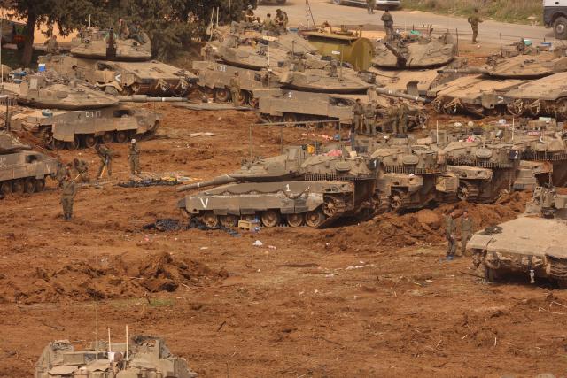 (260313) -- JERUSALEM, March 13, 2026 (Xinhua) -- Israeli troops stage at a staging area in northern Israel near the border with Lebanon, March 13, 2026. The Israeli army said Friday in a statement that it has begun a broad reinforcement of troops along the northern border with Lebanon to strengthen "readiness for various offensive and defensive scenarios," amid ongoing fighting with Hezbollah. (Photo by Gil Cohen Magen/Xinhua)