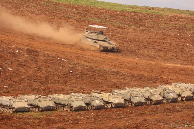 (260313) -- JERUSALEM, March 13, 2026 (Xinhua) -- Israeli troops stage at a staging area in northern Israel near the border with Lebanon, March 13, 2026. The Israeli army said Friday in a statement that it has begun a broad reinforcement of troops along the northern border with Lebanon to strengthen "readiness for various offensive and defensive scenarios," amid ongoing fighting with Hezbollah. (Photo by Gil Cohen Magen/Xinhua)