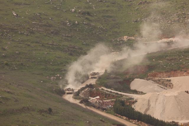 (260313) -- JERUSALEM, March 13, 2026 (Xinhua) -- Israeli tanks drive in southern Lebanon near the border, as seen from northern Israel, March 13, 2026. The Israeli army said Friday in a statement that it has begun a broad reinforcement of troops along the northern border with Lebanon to strengthen "readiness for various offensive and defensive scenarios," amid ongoing fighting with Hezbollah. (Photo by Gil Cohen Magen/Xinhua)