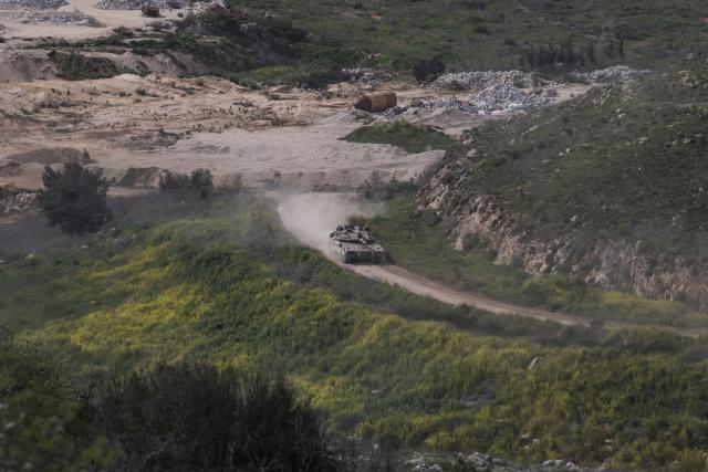 (260313) -- JERUSALEM, March 13, 2026 (Xinhua) -- An Israeli tank drives in southern Lebanon near the border, as seen from northern Israel, March 13, 2026. The Israeli army said Friday in a statement that it has begun a broad reinforcement of troops along the northern border with Lebanon to strengthen "readiness for various offensive and defensive scenarios," amid ongoing fighting with Hezbollah. (Xinhua/Chen Junqing)