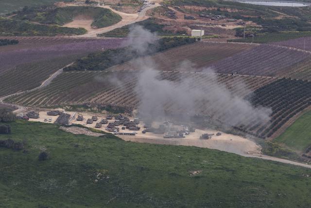 (260313) -- JERUSALEM, March 13, 2026 (Xinhua) -- An Israeli military staging area in northern Israel near the border with Lebanon is hit by shells fired from Lebanon, March 13, 2026. The Israeli army said Friday in a statement that it has begun a broad reinforcement of troops along the northern border with Lebanon to strengthen "readiness for various offensive and defensive scenarios," amid ongoing fighting with Hezbollah. (Xinhua/Chen Junqing)