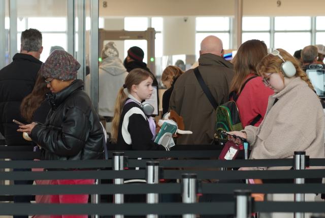 (260313) -- NEW YORK, March 13, 2026 (Xinhua) -- People line up to go through security at LaGuardia Airport in New York, the United States, on March 13, 2026. Major U.S. airports are seeing long lines at security checkpoints amid an ongoing partial government shutdown that has dragged on for nearly a month. (Xinhua/Zhang Fengguo)