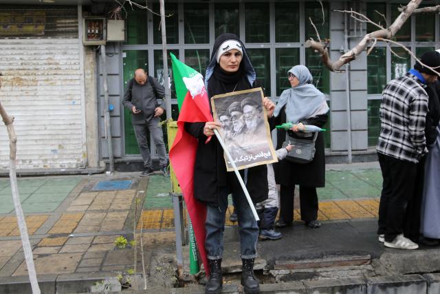 (260313) -- TEHRAN, March 13, 2026 (Xinhua) -- A woman attends a mass rally to mark International Quds Day in Tehran, capital of Iran, March 13, 2026. People across Iran on Friday took to the streets to mark International Quds Day, an annual event expressing support for Palestinians and condemnation of Israeli actions.
   In the capital, people marched from 10 different locations towards the iconic Enghelab Square in central Tehran, while waving Iran's flags and holding pictures of Iran's late Supreme Leader Ali Khamenei and his successor, Mojtaba Khamenei. (Xinhua)