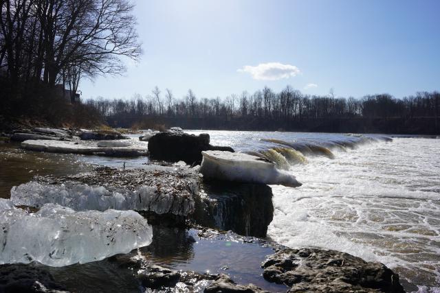 (260314) -- KULDIGA, March 14, 2026 (Xinhua) -- The Venta Rapid, the widest natural waterfall in Europe, is pictured as the River Venta sees rising water level due to melting snow in Kuldiga, Latvia, March 13, 2026. (Xinhua/Chen Yufen)