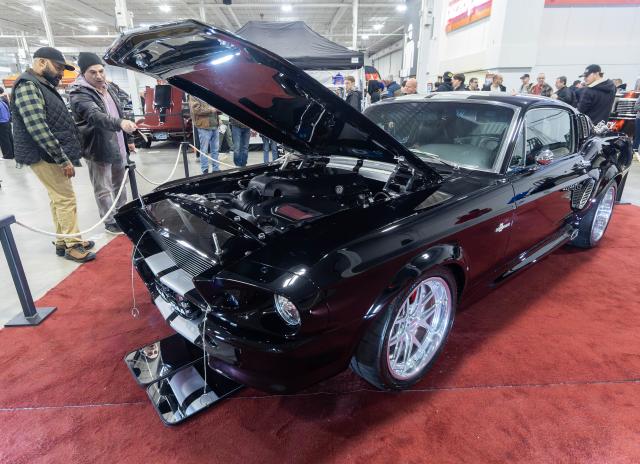 (260314) -- MISSISSAUGA, March 14, 2026 (Xinhua) -- People view a custom vehicle at the 2026 Motorama Custom Car & Motorsports Expo in Mississauga, the Greater Toronto Area, Canada, March 13, 2026.
  The three-day event kicked off here on Friday, showcasing more than 400 custom vehicles. (Photo by Zou Zheng/Xinhua)