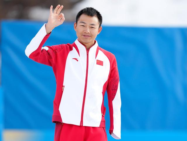 (260314) -- TESERO, March 14, 2026 (Xinhua) -- Gold medalist Cai Jiayun of China poses on the podium after the para biathlon men's sprint pursuit standing at the Milan-Cortina 2026 Paralympic Winter Games in Tesero, Italy, March 13, 2026. (Xinhua/Hou Zhaokang)