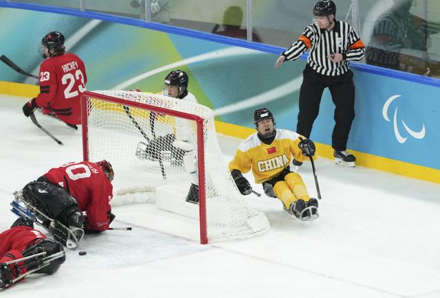 (260314) -- MILAN, March 14, 2026 (Xinhua) -- Zhu Zhanfu (R, front) of China celebrates scoring during the Para Ice Hockey semifinal match between the Canada and China at the Milan-Cortina 2026 Paralympic Winter Games in Milan , Italy, March 13, 2025. (Xinhua/Hou Jun)
