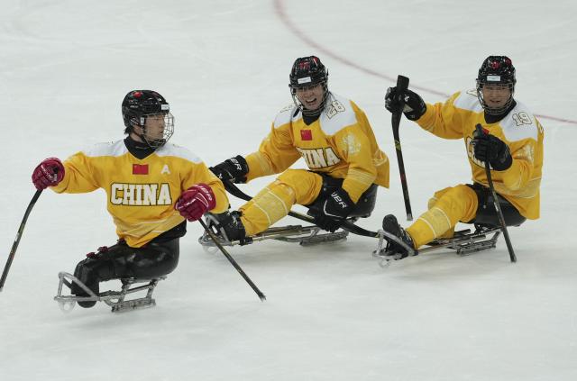 (260314) -- MILAN, March 14, 2026 (Xinhua) -- Players of China celebrate scoring during the Para Ice Hockey semifinal match between the Canada and China at the Milan-Cortina 2026 Paralympic Winter Games in Milan , Italy, March 13, 2025. (Xinhua/Hou Jun)