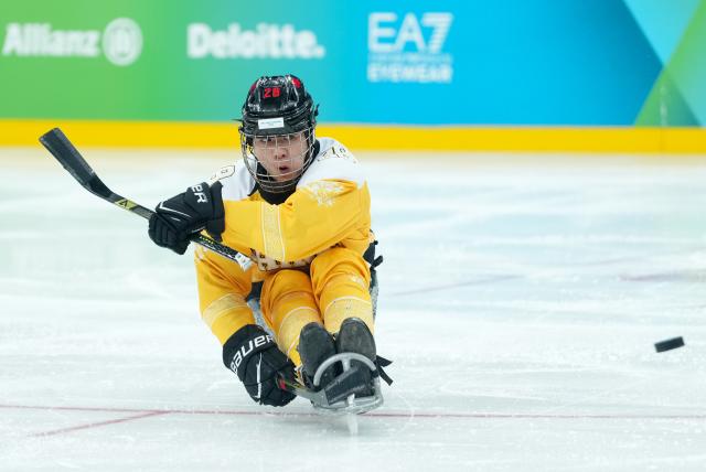 (260314) -- MILAN, March 14, 2026 (Xinhua) -- Tian Jintao of China scores during the Para Ice Hockey semifinal match between the Canada and China at the Milan-Cortina 2026 Paralympic Winter Games in Milan , Italy, March 13, 2025. (Xinhua/Li Jing)