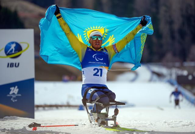 (260314) -- TESERO, March 14, 2026 (Xinhua) -- Yerbol Khamitov of Kazakhstan celebrates after winning the para biathlon men's sprint pursuit sitting at the Milan-Cortina 2026 Paralympic Winter Games in Tesero, Italy, March 13, 2026. (Xinhua/Hou Zhaokang)