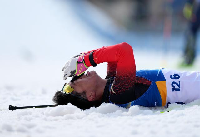 (260314) -- BEIJING, March 14, 2026 (Xinhua) -- Yu Shuang of China reacts after winning the final of Para Biathlon Men's Sprint Pursuit Vision Impaired event at the Milan-Cortina 2026 Paralympic Winter Games in Tesero, Italy, March 13, 2026. (Xinhua/Hou Zhaokang)