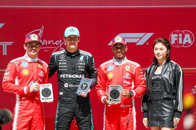(260314) -- SHANGHAI, March 14, 2026 (Xinhua) -- First-placed Mercedes' George Russell  (2nd L) of Britain, second-placed Ferrari's Charles Leclerc (1st L) of Monaco and third-placed Ferrari's Lewis Hamilton of Britain (2nd R) pose on the podium after the Sprint race of Formula One Chinese Grand Prix at Shanghai International Circuit in Shanghai, China, March 14, 2026. (Photo by Qian Jun/Xinhua)