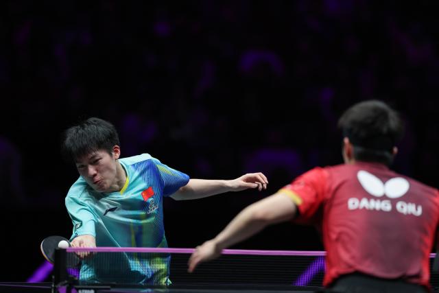 (260314) -- CHONGQING, March 14, 2026 (Xinhua) -- Wen Ruibo (L) of China hits a return during the men's singles quarterfinal match between Wen Ruibo of China and Qiu Dang of Germany at the WTT Champions Chongqing 2026 in southwest China's Chongqing, March 14, 2026. (Xinhua/Huang Wei)