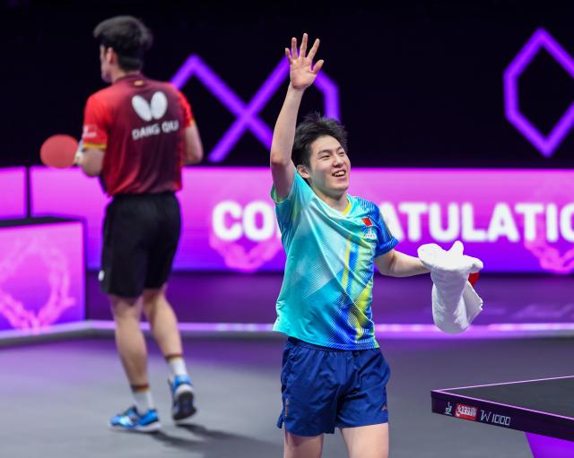 (260314) -- CHONGQING, March 14, 2026 (Xinhua) -- Wen Ruibo of China celebrates after winning the men's singles quarterfinal match between Wen Ruibo of China and Qiu Dang of Germany at the WTT Champions Chongqing 2026 in southwest China's Chongqing, March 14, 2026. (Xinhua/Tang Yi)