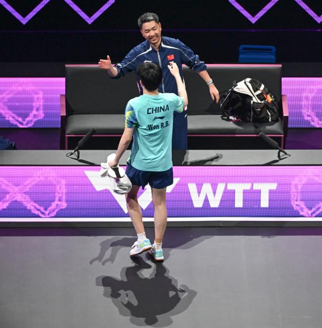 (260314) -- CHONGQING, March 14, 2026 (Xinhua) -- Wen Ruibo of China celebrates with his coach Liu Heng after the men's singles quarterfinal match between Wen Ruibo of China and Qiu Dang of Germany at the WTT Champions Chongqing 2026 in southwest China's Chongqing, March 14, 2026. (Xinhua/Chen Cheng)