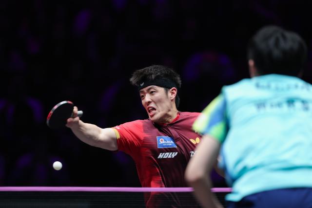 (260314) -- CHONGQING, March 14, 2026 (Xinhua) -- Qiu Dang of Germany hits a return during the men's singles quarterfinal match between Wen Ruibo of China and Qiu Dang of Germany at the WTT Champions Chongqing 2026 in southwest China's Chongqing, March 14, 2026. (Xinhua/Huang Wei)
