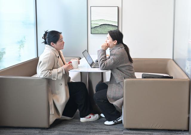 (260314) -- NANJING, March 14, 2026 (Xinhua) -- Gu Yanyan (L), founder of a startup company, talks with a fellow entrepreneur at a one-person-company (OPC) community in Nanjing, east China's Jiangsu Province, March 12, 2026.
  The widespread rise of AI is modifying China's labor market in ways that go far beyond job replacement or creation. It has generated new professions, lowered the threshold for starting a business, and empowered employees to upgrade their skills in a bid to stay competitive.
  The OPC model is witnessing rapid development in China, fueled by the coding capabilities of AI models and support from local governments, resulting in a greater diversity of products. This shift mirrors a broader evolution within China's professional landscape. (Xinhua/Ji Chunpeng)