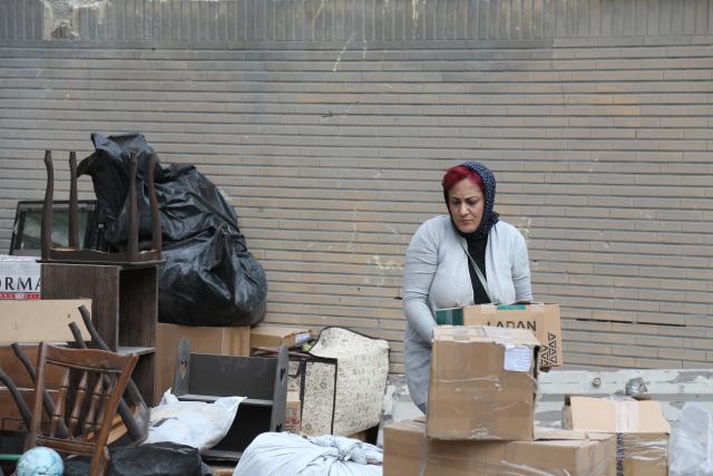 (260314) -- TEHRAN, March 14, 2026 (Xinhua) -- A woman sorts belongings searched from destroyed houses in Tehran, Iran, March 12, 2026. (Xinhua/Shadati)