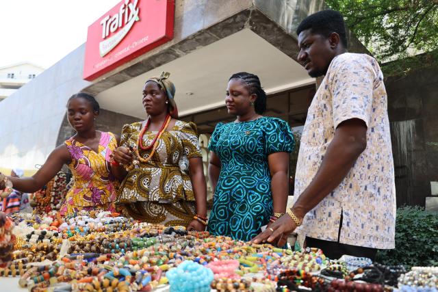 (260314) -- ACCRA, March 14, 2026 (Xinhua) -- Visitors buy beads during the opening of the 2026 Ghana Culture Week in Accra, Ghana, March 13, 2026. Ghana on Friday launched the 2026 Ghana Culture Week celebrations with displays of traditional dance, art exhibitions and cultural performances highlighting the country's rich heritage. (Photo by Seth/Xinhua)
