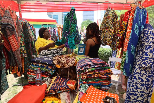 (260314) -- ACCRA, March 14, 2026 (Xinhua) -- People visit a local fabric booth during the opening of the 2026 Ghana Culture Week in Accra, Ghana, March 13, 2026. Ghana on Friday launched the 2026 Ghana Culture Week celebrations with displays of traditional dance, art exhibitions and cultural performances highlighting the country's rich heritage. (Photo by Seth/Xinhua)