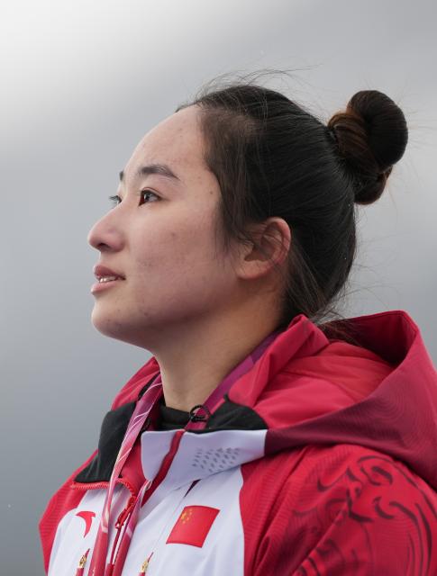 (260314) -- CORTINA D'AMPEZZO, March 14, 2026 (Xinhua) -- Gold medalist Zhang Wenjing of China reacts during the awarding ceremony for the para alpine skiing women's slalom sitting event at the Milan-Cortina 2026 Paralympic Winter Games in Cortina D'ampezzo, Italy, March 14, 2026. (Xinhua/Wang Kaiyan)