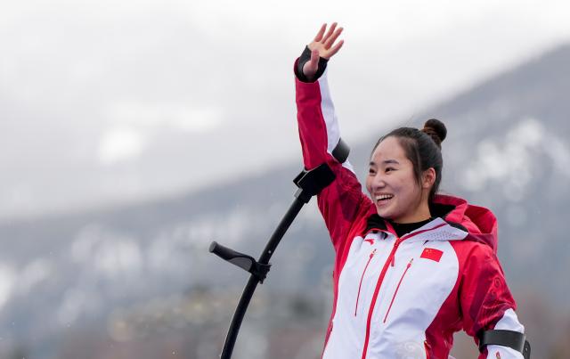 (260314) -- CORTINA D'AMPEZZO, March 14, 2026 (Xinhua) -- Gold medalist Zhang Wenjing of China reacts during the awarding ceremony for the para alpine skiing women's slalom sitting event at the Milan-Cortina 2026 Paralympic Winter Games in Cortina D'ampezzo, Italy, March 14, 2026. (Xinhua/Wang Kaiyan)