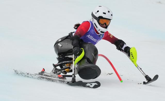 (260314) -- CORTINA D'AMPEZZO, March 14, 2026 (Xinhua) -- Zhang Wenjing of China competes during the para alpine skiing women's slalom sitting event at the Milan-Cortina 2026 Paralympic Winter Games in Cortina D'ampezzo, Italy, March 14, 2026. (Xinhua/Wang Kaiyan)