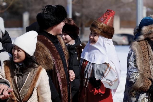 (260314) -- ASTANA, March 14, 2026 (Xinhua) -- People greet each other during a Nauryz festival celebration in Astana, Kazakhstan, March 14, 2026. Regarded as the beginning of a New Year and one of the most important festivals in Central Asian countries, Nauryz (also known as Nowruz) marks the first day of spring. (Photo by Kalizhan Ospanov/Xinhua)