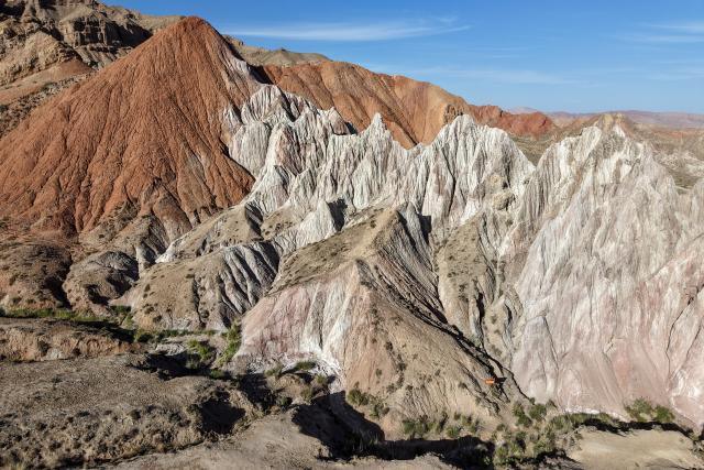 (260708) -- SUNAN, July 8, 2026 (Xinhua) -- An aerial drone photo taken on July 7, 2026 shows the view of a geopark in Sunan Yugur Autonomous County of Zhangye, northwest China's Gansu Province. The geopark covers an area of 17.34 square kilometers. The park features unique landforms with towering peaks, rugged mountains, jagged rock pillars, and vibrant colors. (Xinhua/Lang Bingbing)