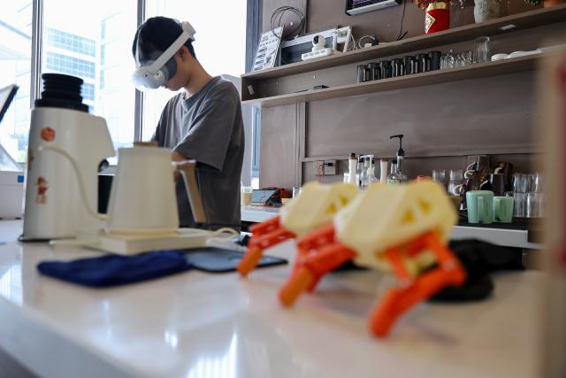 (260708) -- GUIYANG, July 8, 2026 (Xinhua) -- A data collector captures real-world inputs for embodied intelligent devices at a cafe scenario in Yunyan District of Guiyang City, southwest China's Guizhou Province, July 6, 2026. With the rapid development of embodied artificial intelligence (AI), a new profession, trainers of embodied AI, has emerged, which comprise roles such as data collectors.
   In Guizhou, China's first national comprehensive big data pilot zone, data collectors are producing the essential "raw material" for the digital economy, bridging the physical and digital worlds.
   Data collection professionals show a rising demand in recent years, becoming an emerging career path in digital job market. (Xinhua/Liu Xu)