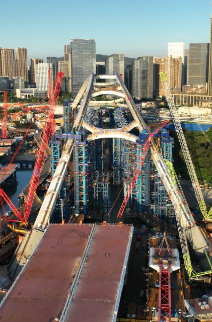 (260708) -- XIAMEN, July 8, 2026 (Xinhua) -- A drone photo taken on July 8, 2026 shows a view of the construction site of Guanyinshan Interchange, a project of the Xiamen section of the Xiamen-Kinmen bridge, in Xiamen, southeast China's Fujian Province. The two sides of an arch structure of Guanyinshan Interchange of the Xiamen section of the Xiamen-Kinmen bridge were joined together on Wednesday. (Xinhua/Lin Shanchuan)