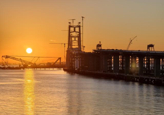 (260708) -- XIAMEN, July 8, 2026 (Xinhua) -- This photo taken on July 8, 2026 shows a view of the construction site of the Xiamen section of the Xiamen-Kinmen bridge, in Xiamen, southeast China's Fujian Province. The two sides of an arch structure of Guanyinshan Interchange of the Xiamen section of the Xiamen-Kinmen bridge were joined together on Wednesday. (Xinhua/Lin Shanchuan)
