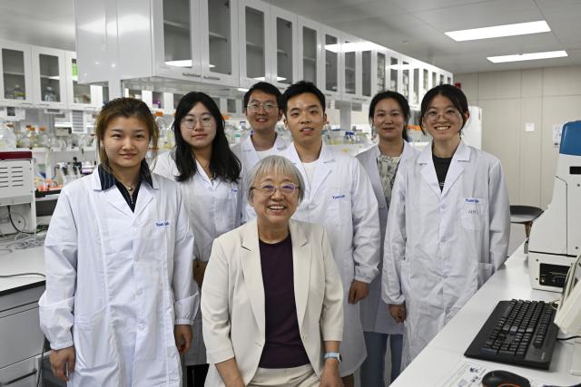 (260708) -- SHANGHAI, July 8, 2026 (Xinhua) -- This photo taken on July 6, 2026 shows Yuan Junying (front), an academician of the Chinese Academy of Sciences (CAS), posing for a group photo with her students at Interdisciplinary Research Center on Biology and Chemistry under the CAS in Shanghai, east China. Basic research is the foundation of all scientific and technological innovation. In recent years, the CAS Shanghai Branch has worked closely with Shanghai to foster basic research. It also provides stable support for young researchers, creating an environment where long-term scientific exploration can generate breakthroughs that serve national priorities and advance cutting-edge research. (Xinhua/Chen Shuo)