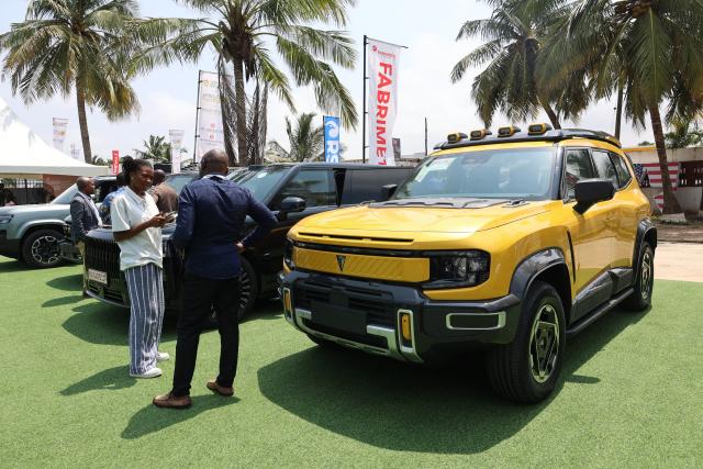 (260708) -- ACCRA, July 8, 2026 (Xinhua) -- People look at Chinese vehicles during the three-day Ghana Investment and Trade Week and Africa Build Show in Accra, Ghana, July 7, 2026. TO GO WITH "Ghana mulls renewable energy, e-mobility investments to power 24-hour economy" (Photo by Seth/Xinhua)