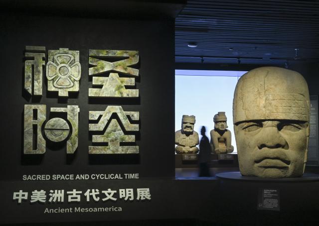 (260708) -- SHANGHAI, July 8, 2026 (Xinhua) -- A visitor views exhibits during the exhibition "On Top of the World Tree: Ancient Civilizations of the Americas" in Shanghai, east China, July 8, 2026. The exhibition showcases a total of 1,129 sets of precious artifacts from cultural institutions in Mexico, Peru and China. It will officially open to the public on July 9 and will run until Nov. 14, 2027. (Xinhua/Chen Haoming)
