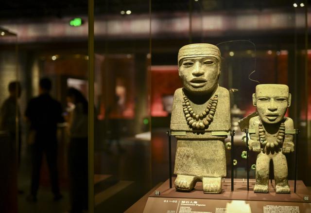 (260708) -- SHANGHAI, July 8, 2026 (Xinhua) -- Exhibits are seen during the exhibition "On Top of the World Tree: Ancient Civilizations of the Americas" in Shanghai, east China, July 8, 2026. The exhibition showcases a total of 1,129 sets of precious artifacts from cultural institutions in Mexico, Peru and China. It will officially open to the public on July 9 and will run until Nov. 14, 2027. (Xinhua/Chen Haoming)