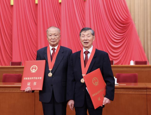 (260708) -- BEIJING, July 8, 2026 (Xinhua) -- Winners of China's top sci-tech award for the year 2025 Chen Liquan (R), a researcher at the Institute of Physics under the Chinese Academy of Sciences (CAS) and a Chinese Academy of Engineering (CAE) academician, and Ben De, a researcher at the China Electronics Technology Group Corporation and a CAE academician, pose for a photo at the Great Hall of the People in Beijing, capital of China, July 8, 2026. A meeting bringing together the national science and technology award conference, the general assemblies of the members of the CAS and the CAE, and the 11th national congress of the China Association for Science and Technology was held here on Wednesday. (Xinhua/Huang Jingwen)