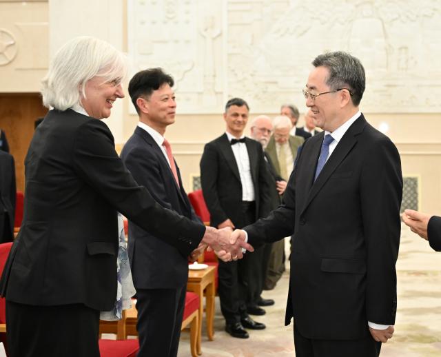 (260708) -- BEIJING, July 8, 2026 (Xinhua) -- Chinese Vice Premier Ding Xuexiang, also a member of the Standing Committee of the Political Bureau of the Communist Party of China Central Committee, meets with and presents medals to foreign experts who won the China International Science and Technology Cooperation Award for the year 2025 at the Great Hall of the People in Beijing, capital of China, July 8, 2026. (Xinhua/Li Xiang)