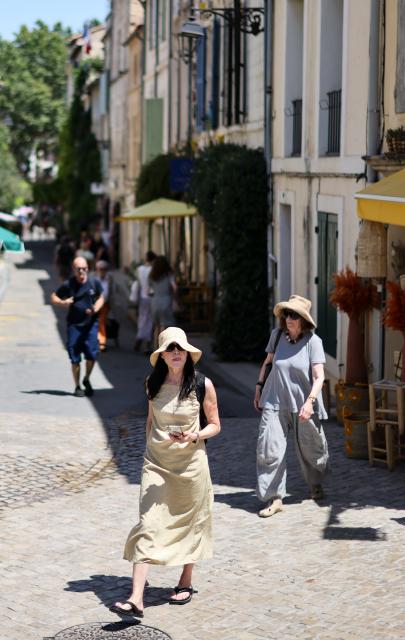 (260708) -- ARLES, July 8, 2026 (Xinhua) -- People walk in the street amid high temperatures in Arles, France, July 8, 2026. France has experienced high temperatures this summer. (Xinhua/Wu Huiwo)