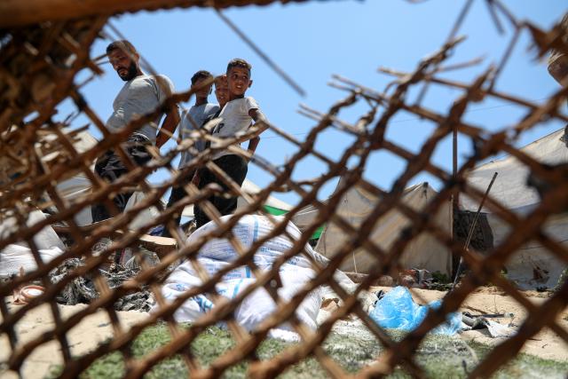 (260709) --BEIJING, July 9, 2026 (Xinhua) -- Displaced Palestinians check damaged tents following an Israeli airstrike at a seaport in Gaza City, on July 7, 2026. (Photo by Rizek Abdeljawad/Xinhua)