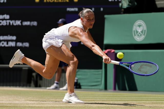 (260709) -- LONDON, July 9, 2026 (Xinhua) -- Marta Kostyuk of Ukraine returns the ball during the women's singles quarterfinal match against Jasmine Paolini of Itlay at the Wimbledon Tennis Championships in London, Britain, on July 8, 2026. (Photo by Dinendra Haria/Xinhua)