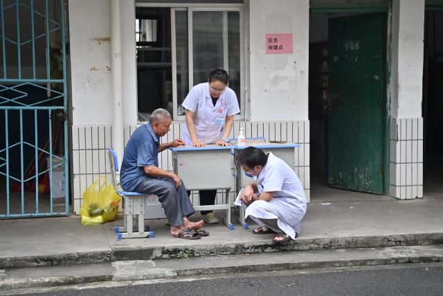 (260709) -- GUIGANG, July 9, 2026 (Xinhua) -- A flood-affected resident receives medical attention at a temporary relocation site in Guigang City, south China's Guangxi Zhuang Autonomous Region, July 8, 2026.
  Guigang has set up 18 temporary relocation sites to shelter flood-affected residents. (Xinhua/Zhou Hua)