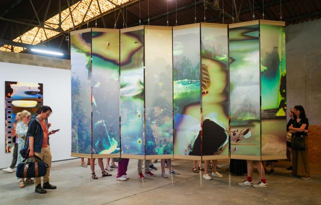 (260709) -- ARLES, July 9, 2026 (Xinhua) -- People view exhibits during an exhibition at the Rencontres d'Arles photography festival in Arles, France, July 8, 2026. The 57th Rencontres d'Arles photography festival lasts from July 6 to October 4. (Xinhua/Wu Huiwo)
