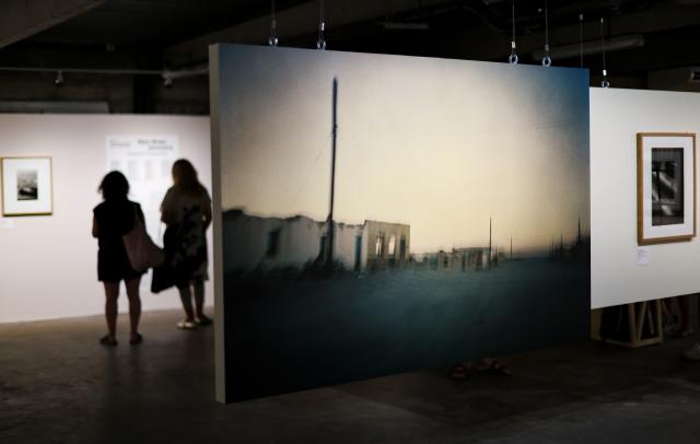 (260709) -- ARLES, July 9, 2026 (Xinhua) -- People view exhibits during an exhibition at the Rencontres d'Arles photography festival in Arles, France, July 8, 2026. The 57th Rencontres d'Arles photography festival lasts from July 6 to October 4. (Xinhua/Wu Huiwo)