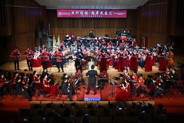 (260709) -- TIANJIN, July 9, 2026 (Xinhua) -- Youth musicians from both sides of the Taiwan Strait perform traditional Chinese pieces during a Chinese folk music concert at Tianjin Conservatory of Music, in north China's Tianjin, July 8, 2026. The concert was staged here on Wednesday evening as part of exchange programs during the 17th Tianjin-Taiwan trade fair. (Xinhua/Sun Fanyue)