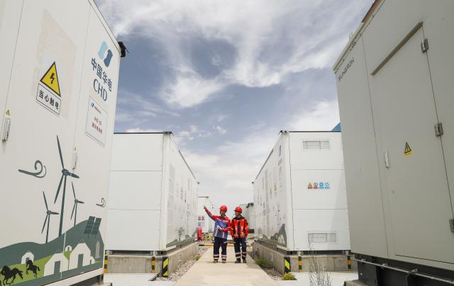(260709) -- DELINGHA, July 9, 2026 (Xinhua) -- Staff members inspect power storage facilities at the joint complex for the Huadian Delingha 1-gigawatt solar energy storage project and 3-megawatt photovoltaic hydrogen production project in Delingha, northwest China's Qinghai Province, July 8, 2026.
  The two projects have generated more than 4 billion kilowatt-hours of electricity, according to China Huadian Corporation, the operator of the duo.
  The projects combine solar power generation, green hydrogen production, and energy storage into a single complex, an approach that helps address the intermittent nature of solar power and boost renewable energy use in desert areas. (Xinhua/Shan Yuqi)