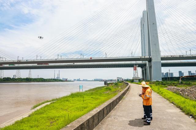 (260709) -- HANGZHOU, July 9, 2026 (Xinhua) -- Railway workers inspect a railway bridge with a drone in Ningbo City, east China's Zhejiang Province, July 9, 2026. China's State Flood Control and Drought Relief Headquarters on Wednesday activated a Level-IV emergency response for flood control and typhoon prevention in the provinces of Zhejiang and Fujian, the Ministry of Emergency Management said.
   Super Typhoon Bavi is forecast to move westward before turning northwestward at a speed of around 15 to 20 km per hour, and may make landfall along the coast between Fuqing in Fujian Province and Wenling in Zhejiang Province on Saturday night, as either a strong typhoon or a typhoon. (Xinhua/Jiang Han)