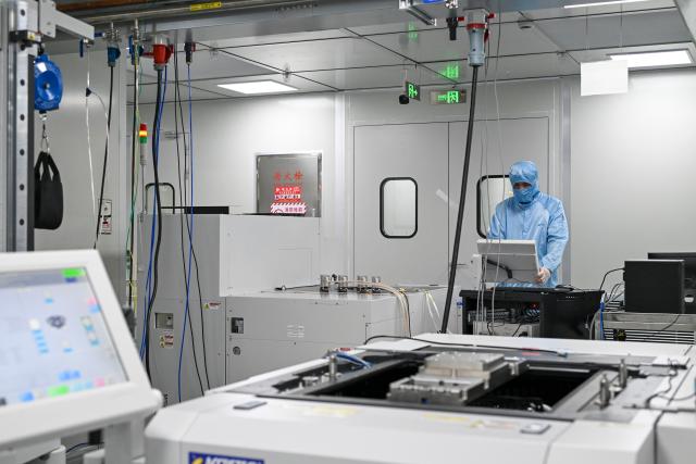 (260709) -- SHANGHAI, July 9, 2026 (Xinhua) -- A staff member works at a testing workshop of a chips testing service platform at the Zhangjiang Hi-Tech 895 Incubator in Pudong New Area, east China's Shanghai, on July 8, 2026. Located in Shanghai's Pudong New Area, the Zhangjiang Hi-Tech 895 Incubator, a specialized entrepreneurship service platform, has incubated more than 1,600 innovative enterprises since its establishment in 2015. 
   Equipped with advanced testing facilities, including a 4,000-square-meter clean test workshop, the incubator provides one-stop public testing services and shared office space for startups. Its testing platform supports the development of high-performance computing chips, large-scale System-on-a-Chip (SoC), memory chips, sensor chips and mixed-signal chips, helping technology startups reduce costs and accelerate innovation. (Xinhua/Chen Shuo)