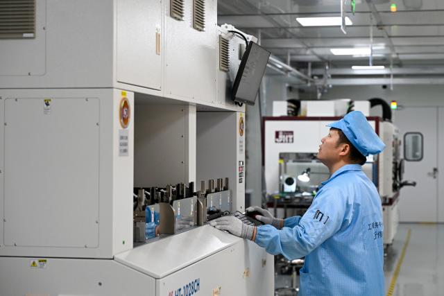 (260709) -- SHANGHAI, July 9, 2026 (Xinhua) -- A staff member debugs a facility at a testing workshop of a chips testing service platform at the Zhangjiang Hi-Tech 895 Incubator in Pudong New Area, east China's Shanghai, on July 8, 2026. Located in Shanghai's Pudong New Area, the Zhangjiang Hi-Tech 895 Incubator, a specialized entrepreneurship service platform, has incubated more than 1,600 innovative enterprises since its establishment in 2015. 
   Equipped with advanced testing facilities, including a 4,000-square-meter clean test workshop, the incubator provides one-stop public testing services and shared office space for startups. Its testing platform supports the development of high-performance computing chips, large-scale System-on-a-Chip (SoC), memory chips, sensor chips and mixed-signal chips, helping technology startups reduce costs and accelerate innovation. (Xinhua/Chen Shuo)